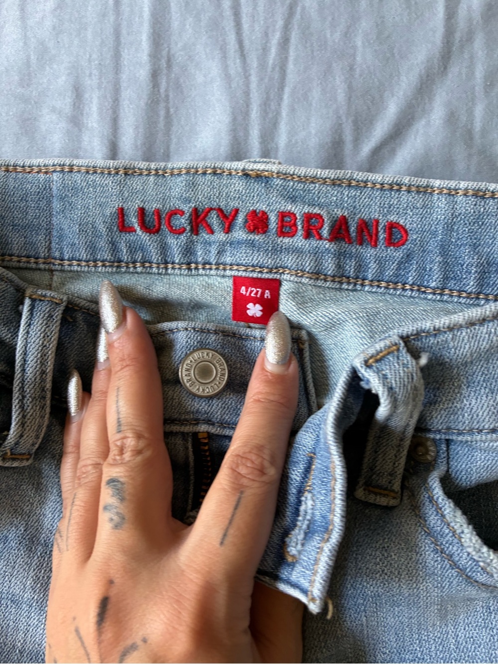 Lucky Brand High-Rise Jeans in Light Blue Denim with Red Logo